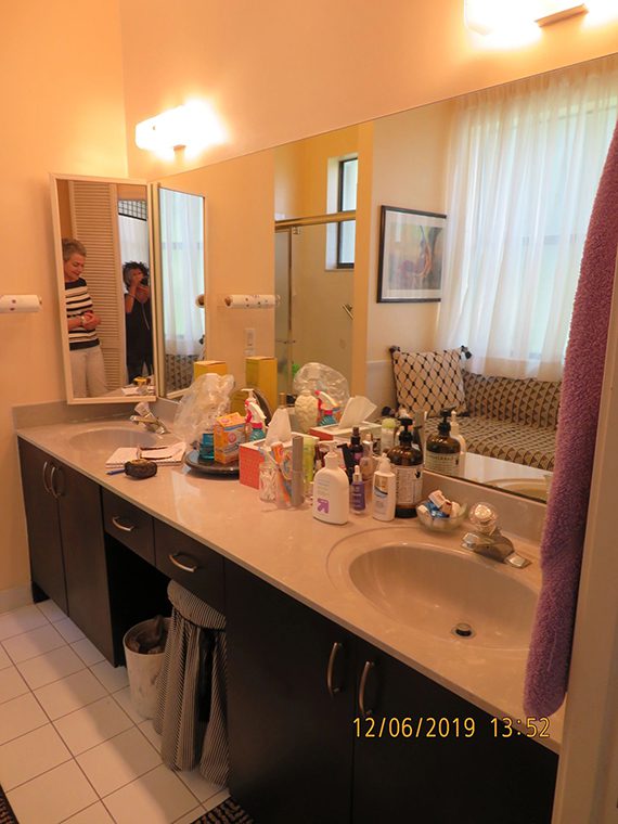 A bathroom with a mirror and a sink.