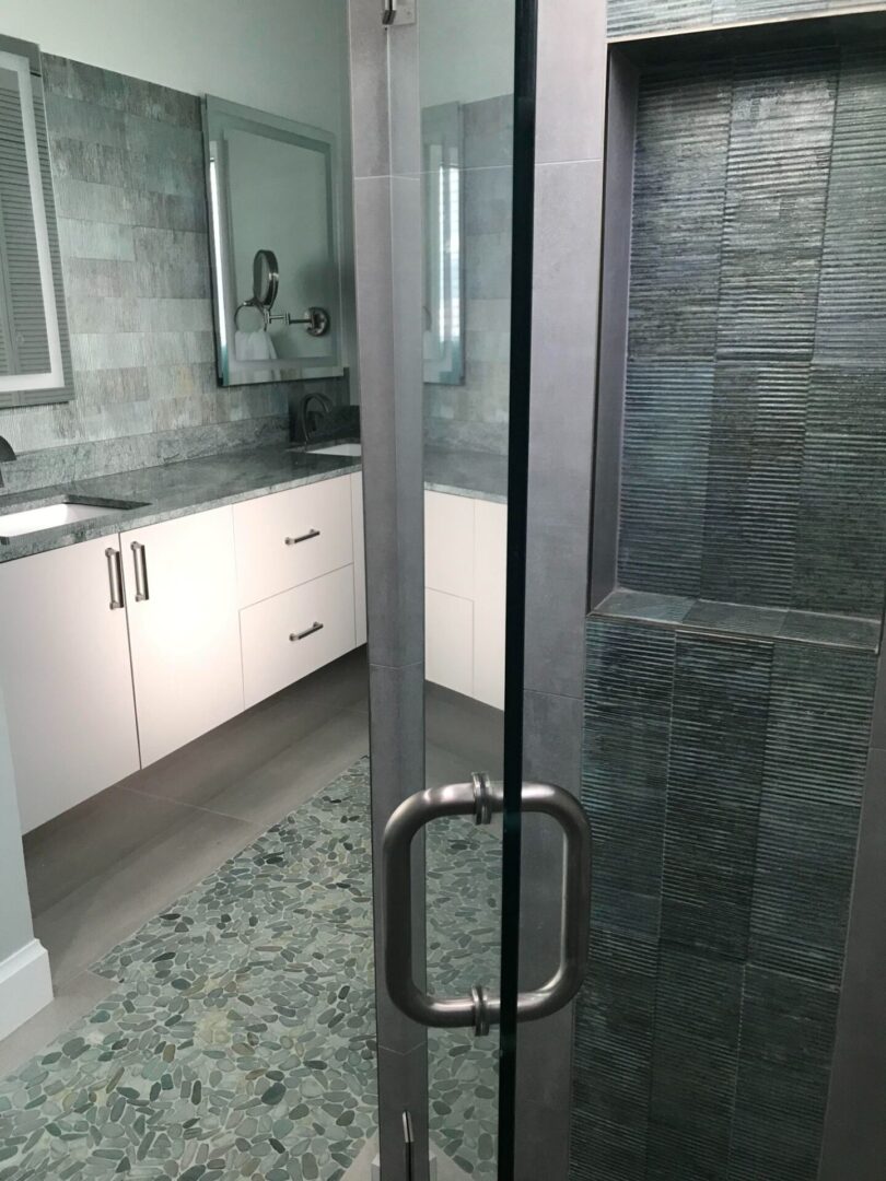 A bathroom with a glass door.