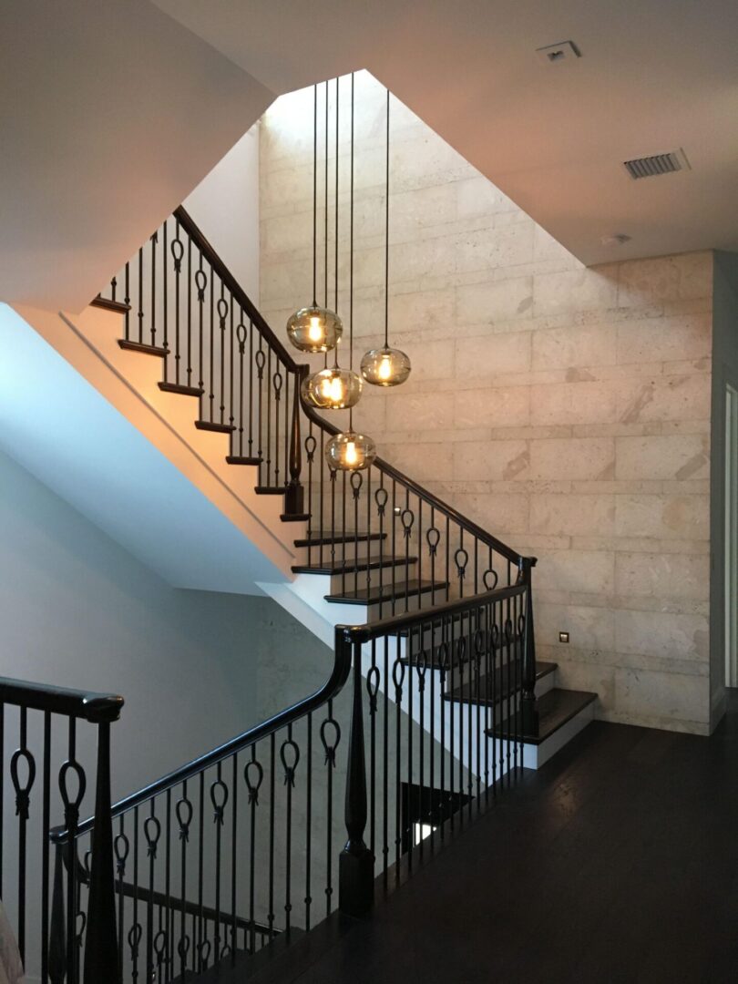 A staircase in a home with wrought iron railings.
